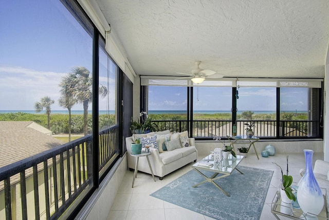 sunroom / solarium with tile patterned flooring, ceiling fan, and a healthy amount of sunlight