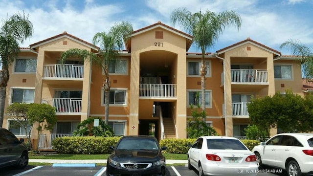 view of building exterior with uncovered parking