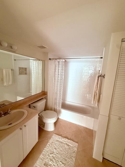 full bathroom with toilet, vanity, visible vents, tile patterned flooring, and shower / bath combination with curtain