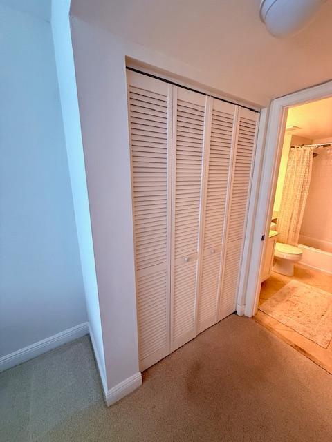 interior space featuring carpet and baseboards