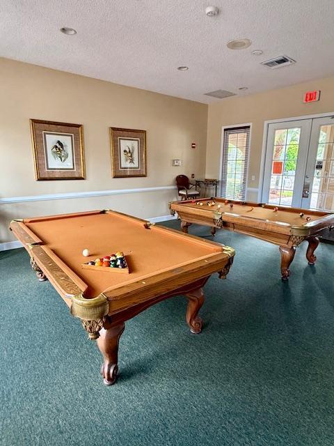 rec room with french doors, carpet floors, a textured ceiling, visible vents, and billiards