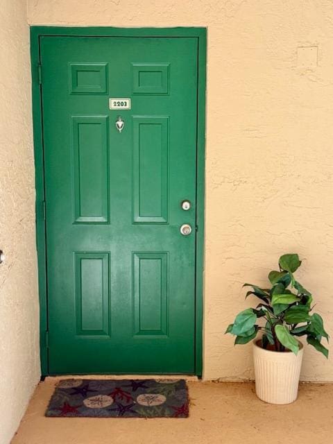 entrance to property with stucco siding