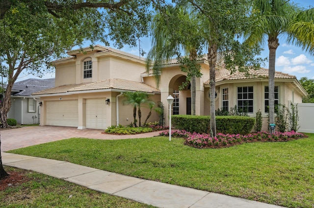 view of front facade featuring a tiled roof, decorative driveway, a garage, and stucco siding