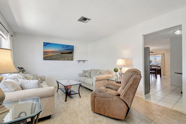 245 Bilbao St, Royal Palm Beach, FL 33411 - living room with a textured ceiling and light tile patterned flooring