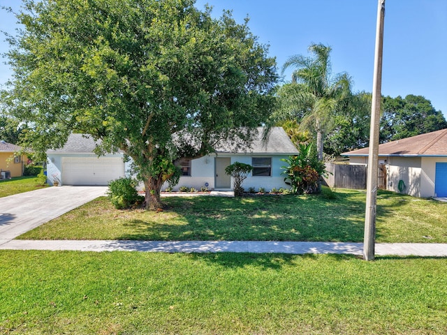 245 Bilbao St, Royal Palm Beach, FL 33411 - view of front of house with driveway and an attached garage