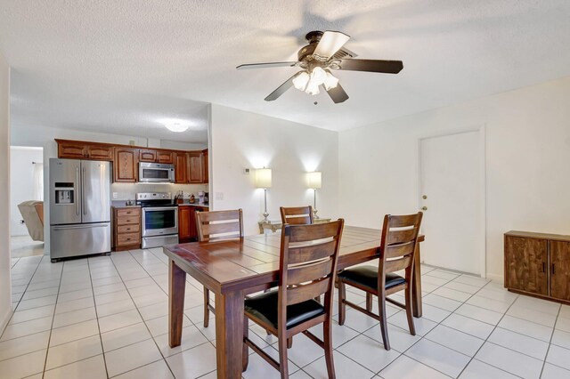 245 Bilbao St, Royal Palm Beach, FL 33411 - dining space with ceiling fan, light tile patterned floors, and a textured ceiling