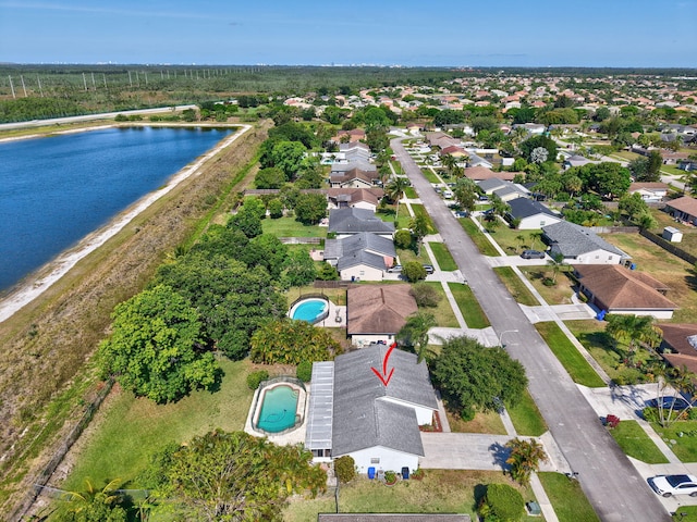 245 Bilbao St, Royal Palm Beach, FL 33411 - aerial view of property and surrounding area with a large body of water, a pool, and nearby suburban area