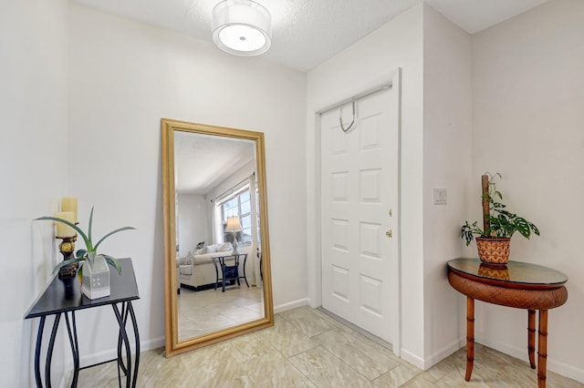 245 Bilbao St, Royal Palm Beach, FL 33411 - entryway featuring baseboards and a textured ceiling