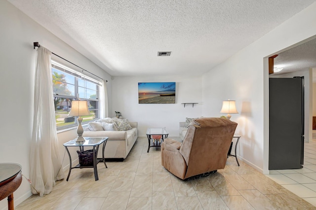 245 Bilbao St, Royal Palm Beach, FL 33411 - living room featuring a textured ceiling and baseboards