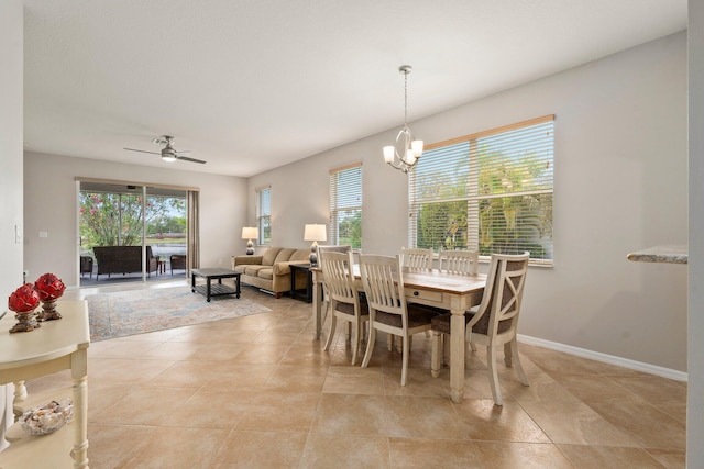 9943 SW Stonegate Dr, Port Saint Lucie, FL 34987 - dining room featuring a ceiling fan, light tile patterned flooring, a chandelier, and baseboards