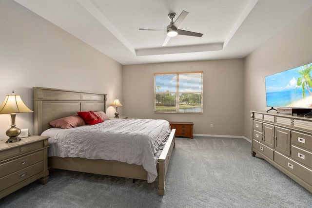 9943 SW Stonegate Dr, Port Saint Lucie, FL 34987 - carpeted bedroom with a raised ceiling, ceiling fan, and baseboards