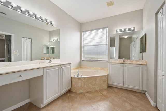 9943 SW Stonegate Dr, Port Saint Lucie, FL 34987 - full bath featuring a garden tub, two vanities, and tile patterned flooring