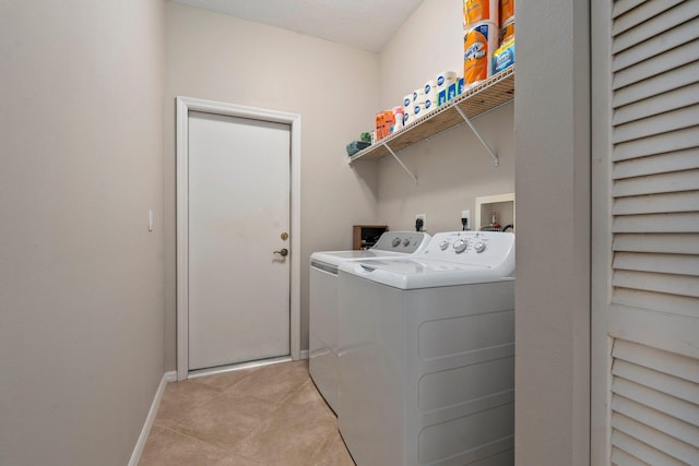 9943 SW Stonegate Dr, Port Saint Lucie, FL 34987 - clothes washing area featuring separate washer and dryer, baseboards, and light tile patterned floors