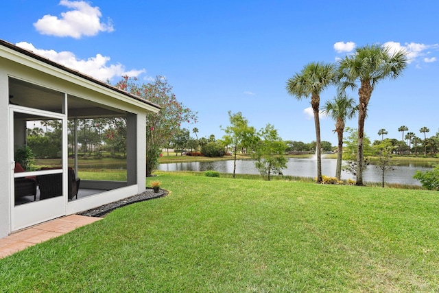 9943 SW Stonegate Dr, Port Saint Lucie, FL 34987 - view of green lawn featuring a sunroom and a water view