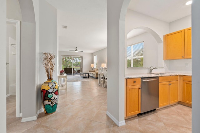 9943 SW Stonegate Dr, Port Saint Lucie, FL 34987 - kitchen with stainless steel dishwasher, a ceiling fan, light tile patterned floors, open floor plan, and a sink