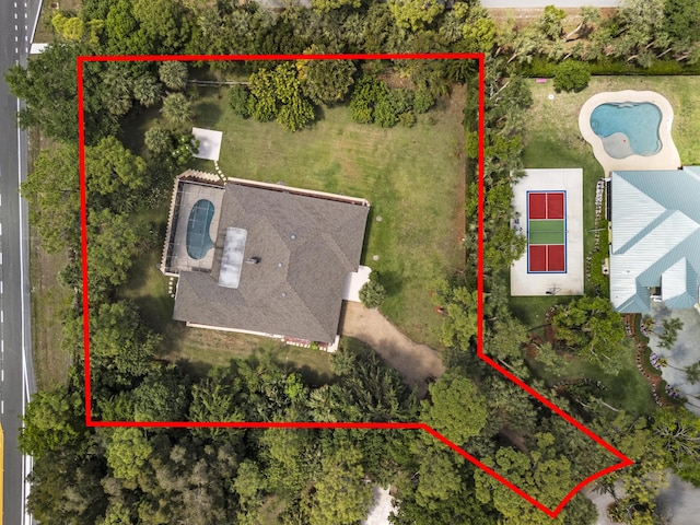 aerial view of property and surrounding area featuring property boundaries highlighted and a pool