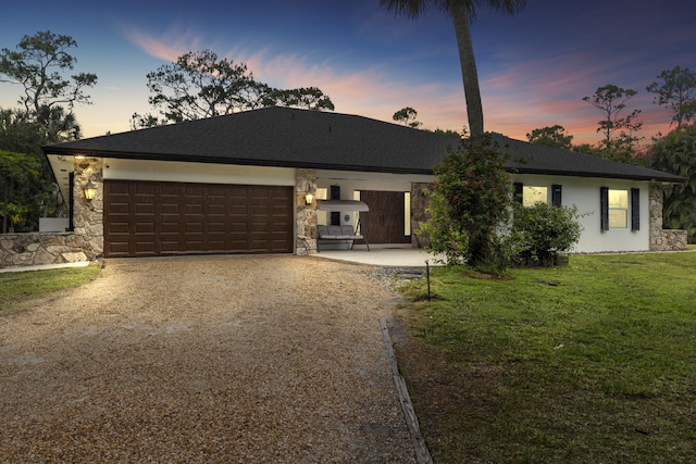 view of front facade featuring a front yard, dirt driveway, a garage, and stone siding