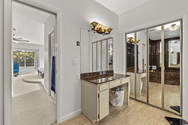 full bath featuring baseboards and ceiling fan with notable chandelier