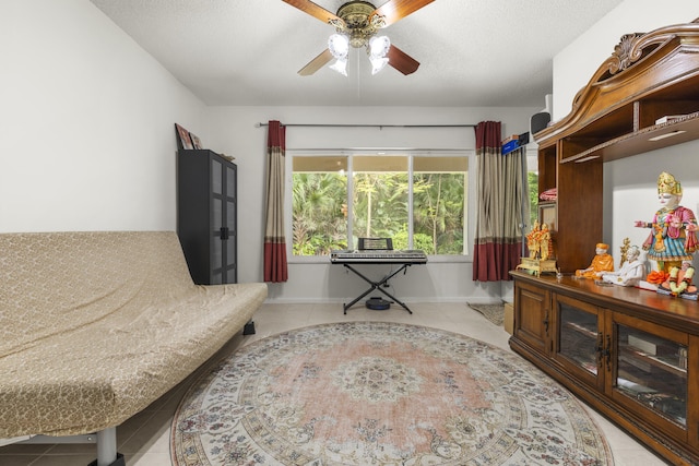 interior space with tile patterned floors, baseboards, and a ceiling fan