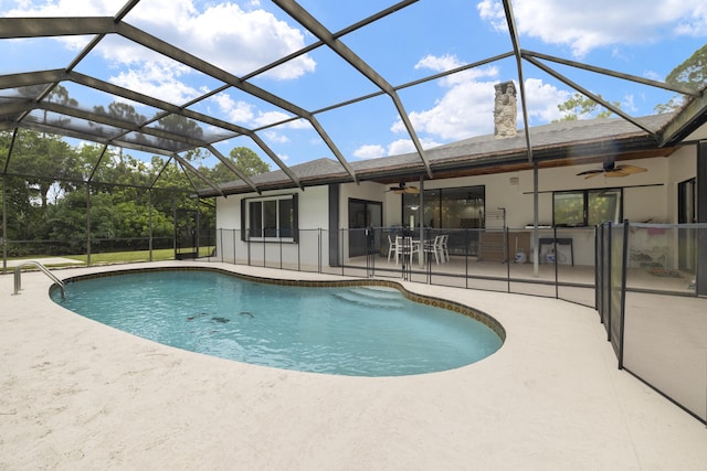 outdoor pool featuring a patio area, ceiling fan, and a lanai