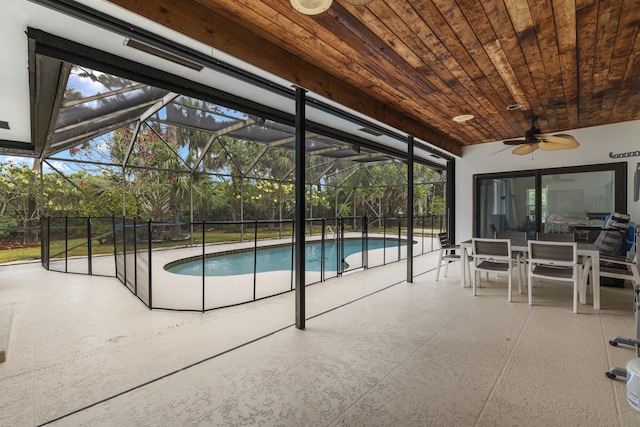 view of swimming pool featuring a lanai, a patio, outdoor dining space, ceiling fan, and a fenced in pool