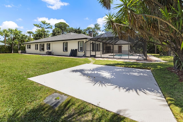 rear view of property featuring a patio, stucco siding, a yard, and central air condition unit