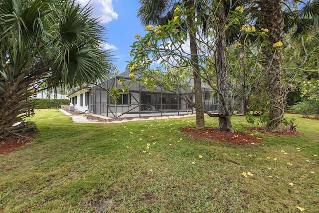 view of yard with a lanai and an outdoor pool