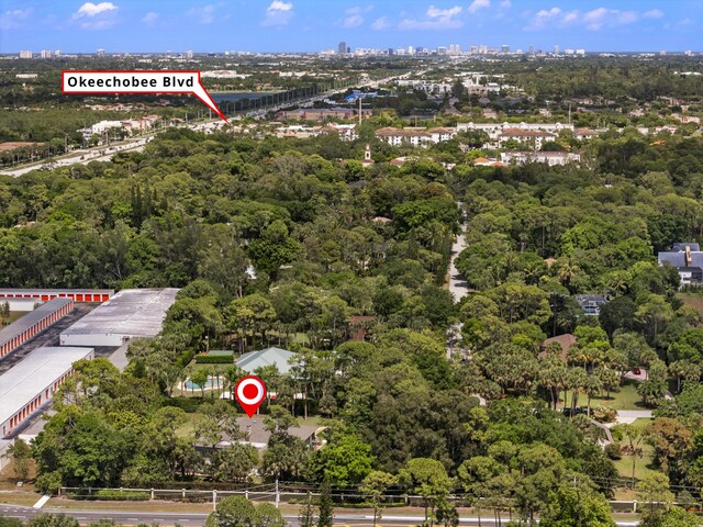 view of property location with a large body of water and a heavily wooded area