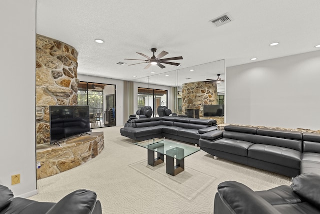 carpeted living room featuring a fireplace, a ceiling fan, visible vents, and recessed lighting