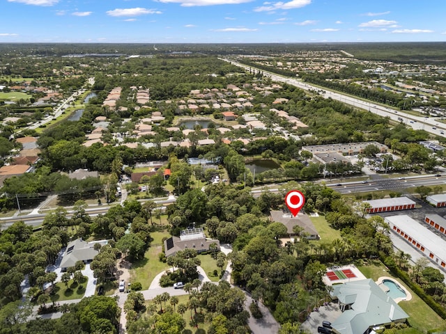 aerial view of property and surrounding area featuring nearby suburban area
