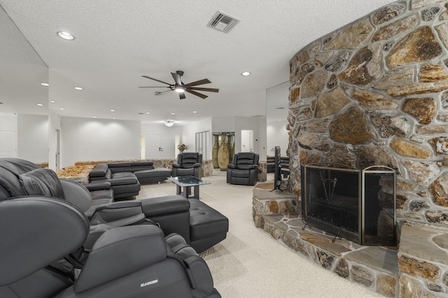 living area featuring a ceiling fan, recessed lighting, a textured ceiling, visible vents, and carpet floors