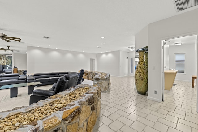 living room featuring light tile patterned floors, visible vents, a ceiling fan, and recessed lighting