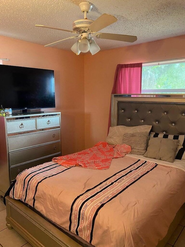 bedroom featuring a ceiling fan and a textured ceiling