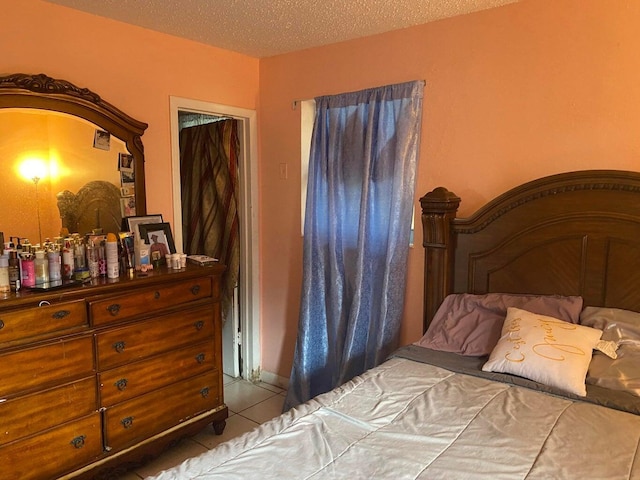 bedroom with tile patterned floors and a textured ceiling
