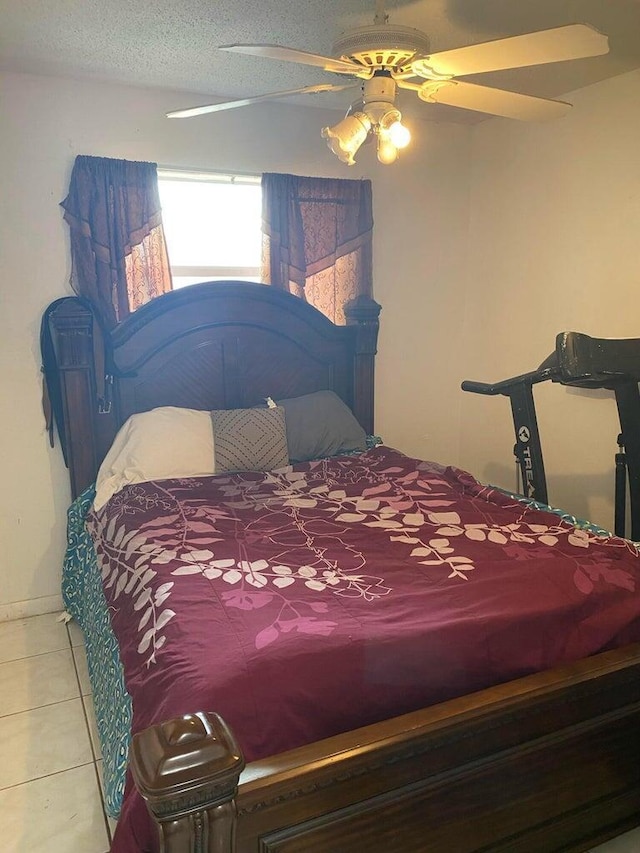 tiled bedroom featuring ceiling fan