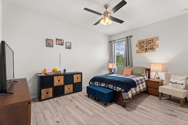 bedroom featuring ceiling fan, baseboards, and light wood-style floors