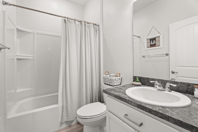 full bath featuring vanity, toilet, wood finished floors, and shower / bath combo