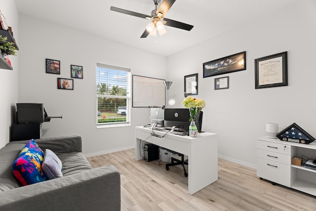 office space featuring light wood finished floors, baseboards, and a ceiling fan