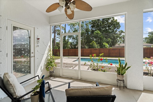 sunroom / solarium with a wealth of natural light, outdoor lounge area, and a ceiling fan