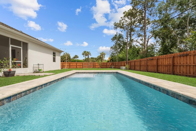 view of swimming pool with a sunroom, a fenced in pool, and a fenced backyard
