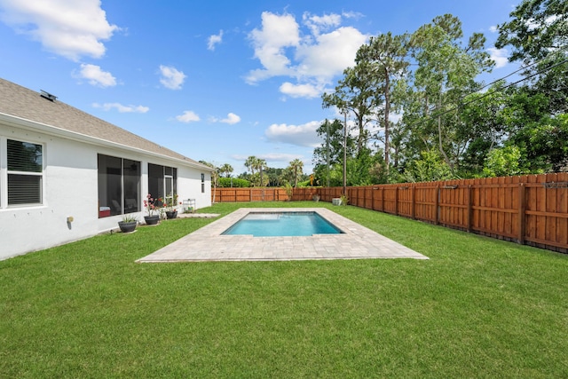 view of pool with a patio, a lawn, and a fenced backyard