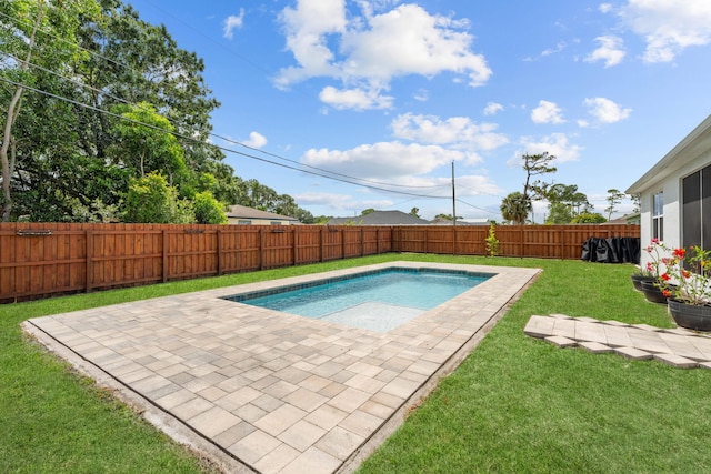 view of pool with a fenced backyard, a patio area, and a yard