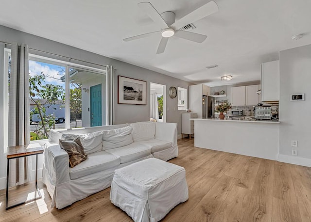 923 N H St, Lake Worth Beach, FL 33460 - living room with baseboards, a ceiling fan, light wood-style flooring, and visible vents