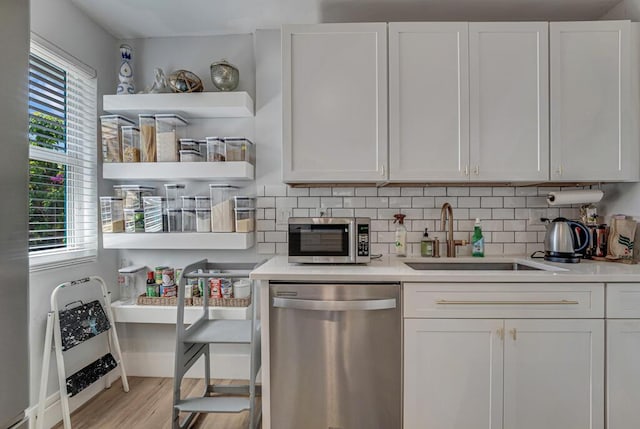 923 N H St, Lake Worth Beach, FL 33460 - kitchen featuring a sink, light countertops, white cabinets, and stainless steel appliances