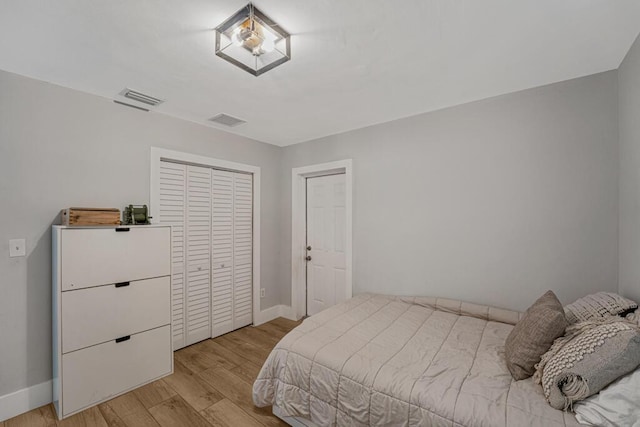 923 N H St, Lake Worth Beach, FL 33460 - bedroom featuring visible vents, light wood finished floors, baseboards, and a closet