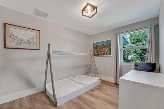 923 N H St, Lake Worth Beach, FL 33460 - bedroom featuring baseboards, visible vents, and light wood-style floors