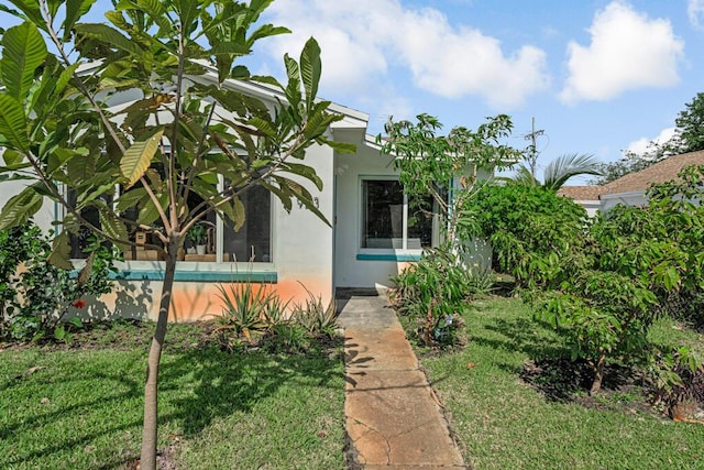 923 N H St, Lake Worth Beach, FL 33460 - view of property exterior featuring stucco siding and a yard