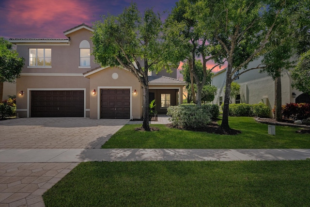 1317 Beacon Cir, Wellington, FL 33414 - view of front of home with stucco siding, decorative driveway, a tiled roof, and a lawn