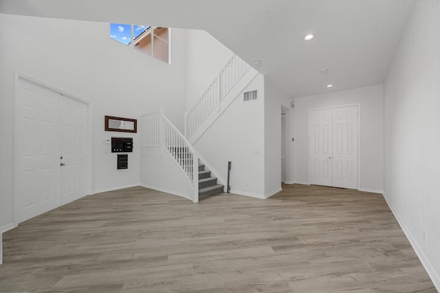 1317 Beacon Cir, Wellington, FL 33414 - foyer entrance with stairs, light wood-type flooring, a towering ceiling, baseboards, and recessed lighting