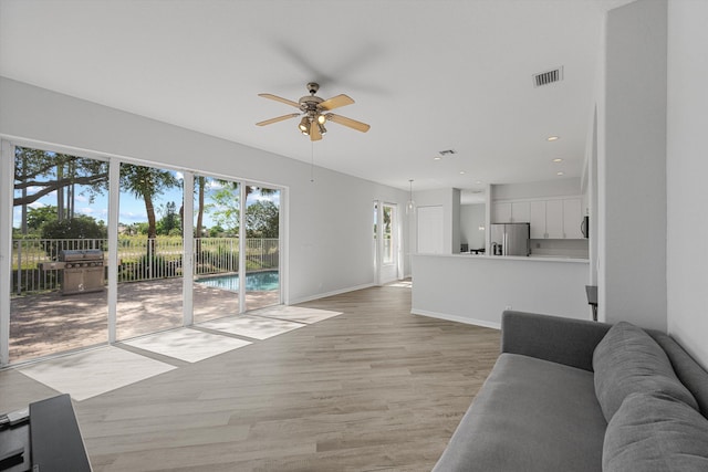 1317 Beacon Cir, Wellington, FL 33414 - living room with ceiling fan, light wood-type flooring, baseboards, and recessed lighting